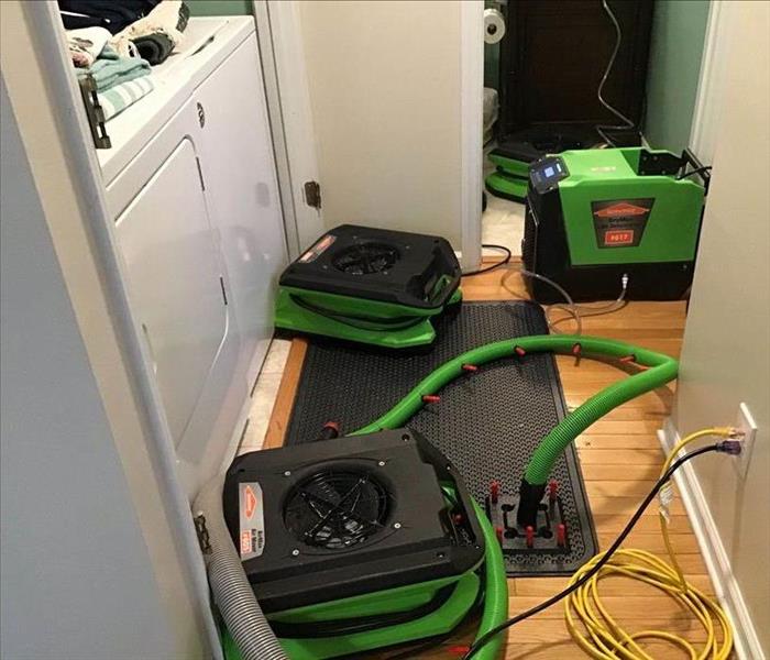 Water damage drying equipment placed in an area that has water damage due to a supply line leak