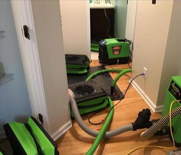 Four air movers placed on the floor to dry area